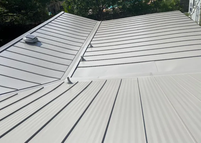 Solar attic fan installed on a metal roof for Roof Ventilation in Lake Park